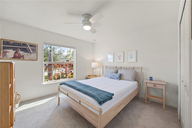 bedroom with carpet, ceiling fan, and a closet