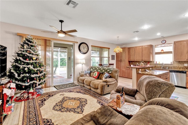 living room featuring light hardwood / wood-style floors, a wealth of natural light, and ceiling fan