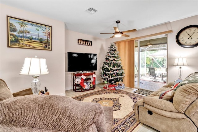 living room featuring ceiling fan and light wood-type flooring