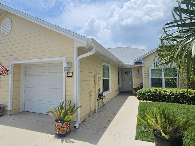 495 9th Pl, Vero Beach, FL 32960 - doorway to property featuring an attached garage and concrete driveway
