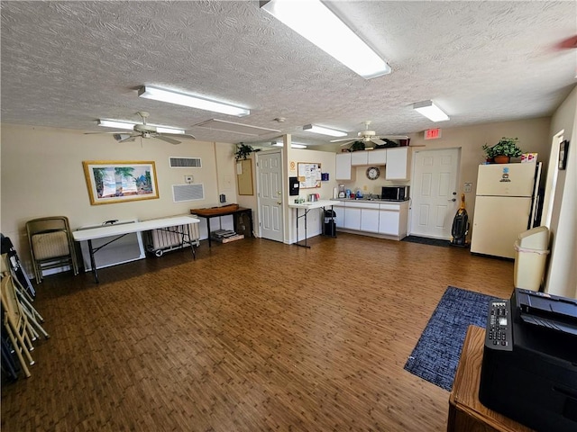 495 9th Pl, Vero Beach, FL 32960 - miscellaneous room with a ceiling fan, attic access, dark wood finished floors, and a textured ceiling