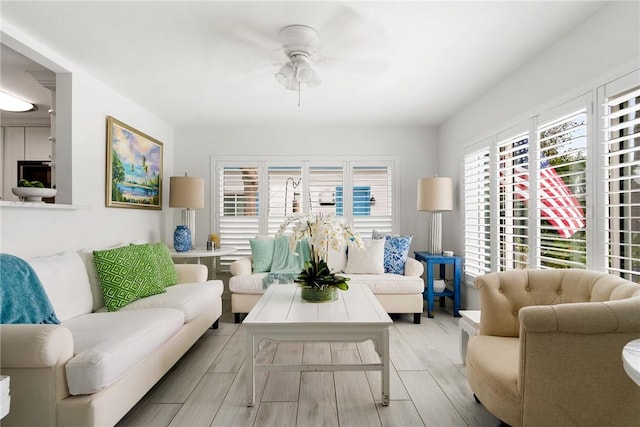 living room featuring ceiling fan and light hardwood / wood-style flooring