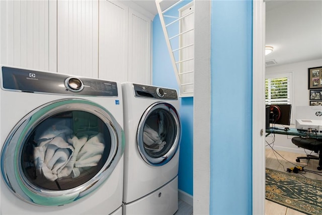 clothes washing area featuring washing machine and dryer