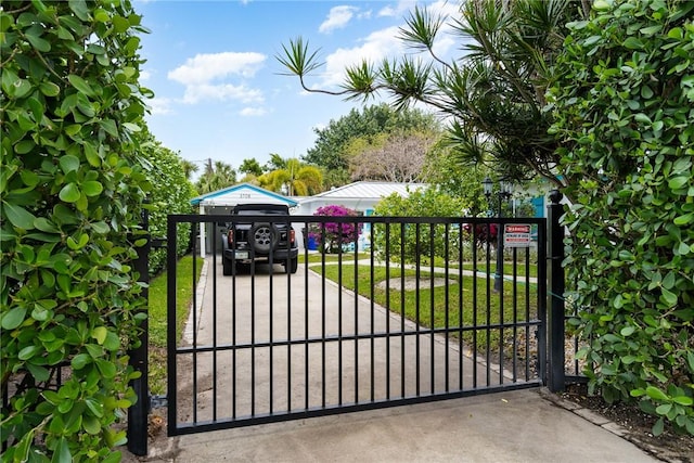 view of gate featuring a yard