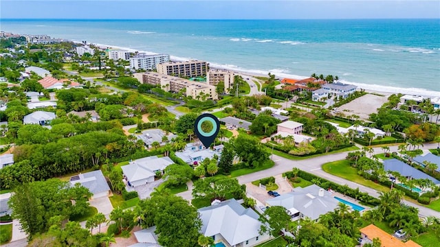 drone / aerial view with a water view and a beach view