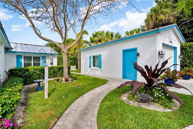 exterior space featuring a garage and a front yard