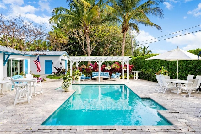 view of swimming pool featuring a patio, an outdoor hangout area, and a pergola