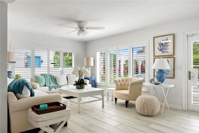 sitting room with ceiling fan, a healthy amount of sunlight, and light wood-type flooring