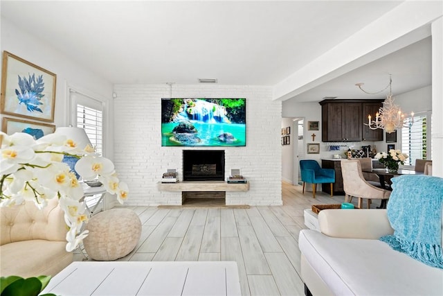 living room with an inviting chandelier and a fireplace