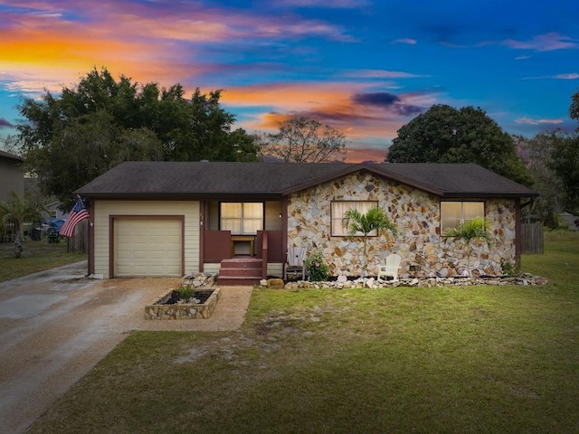 single story home with a garage and a yard