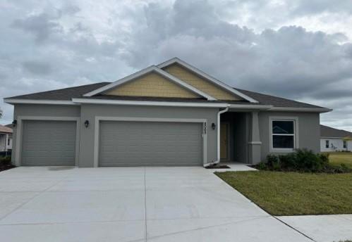 view of front of property featuring a garage and a front lawn