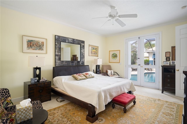 carpeted bedroom featuring ceiling fan, access to exterior, and french doors