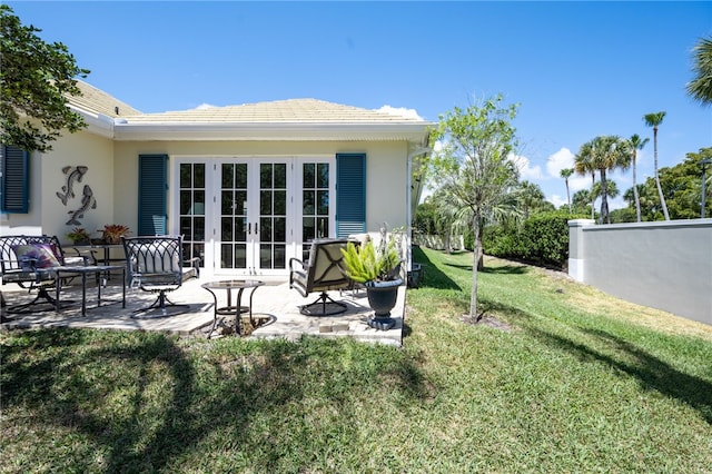 rear view of house with a patio and a yard