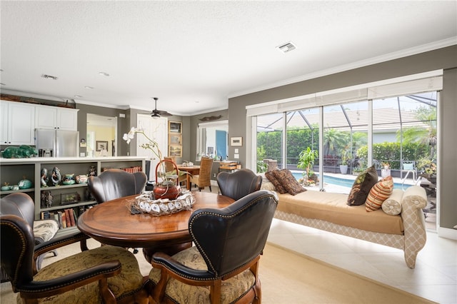 tiled dining room featuring ceiling fan and ornamental molding