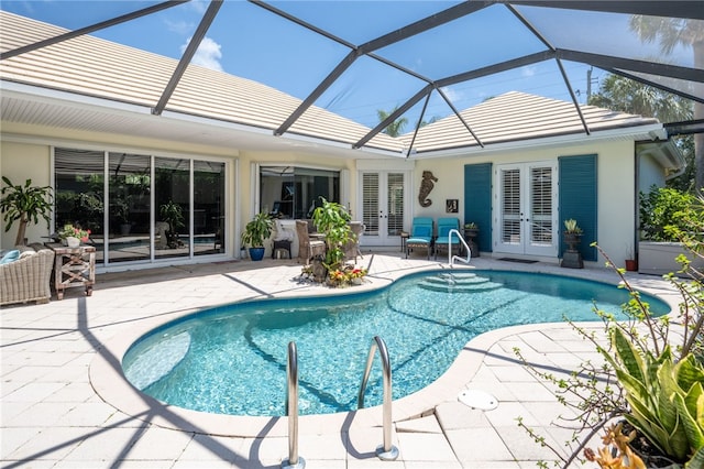 view of pool featuring ceiling fan, a lanai, a patio, and french doors