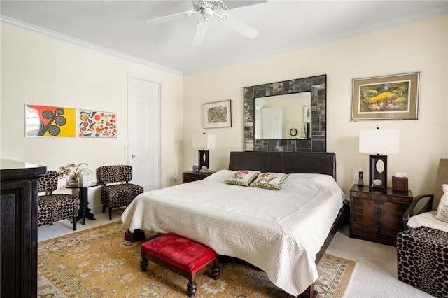 carpeted bedroom with ornamental molding and ceiling fan