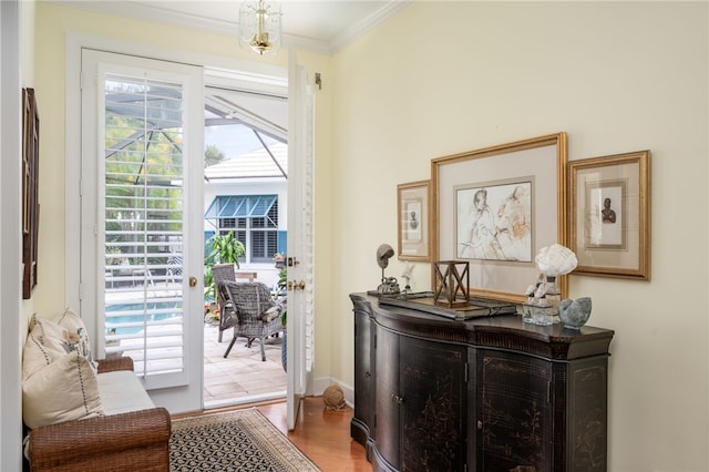 entryway featuring hardwood / wood-style flooring and crown molding