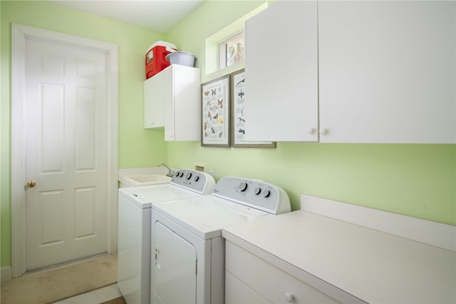 washroom featuring cabinets, sink, and separate washer and dryer