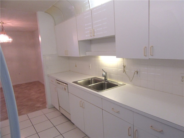 kitchen with white cabinets, dishwasher, sink, light tile patterned flooring, and backsplash