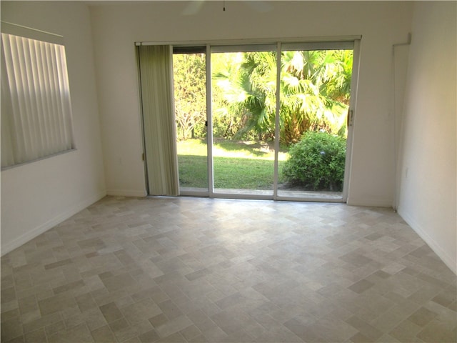 unfurnished room with a wealth of natural light and ceiling fan