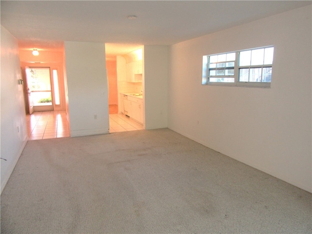 spare room featuring light colored carpet