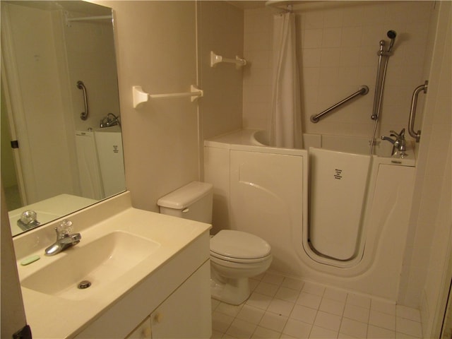 bathroom featuring vanity, tile patterned floors, and toilet