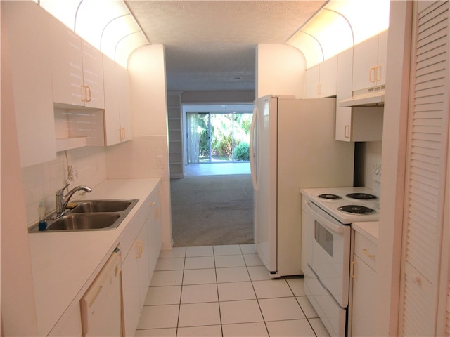 kitchen featuring sink, light tile patterned floors, backsplash, white cabinetry, and white appliances