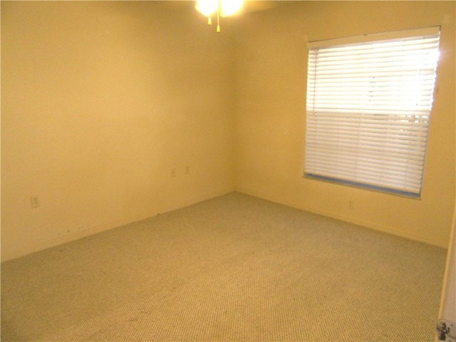 empty room with carpet floors and ceiling fan