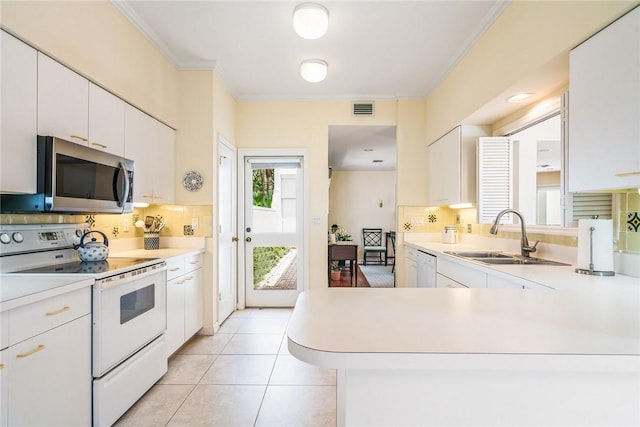 8409 Red Bay Ct Unit 8409, Vero Beach, FL 32963 - kitchen with white appliances, visible vents, light countertops, and ornamental molding