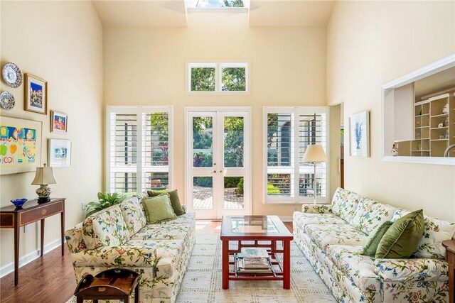 8409 Red Bay Ct Unit 8409, Vero Beach, FL 32963 - living room with french doors, a wealth of natural light, wood finished floors, and a towering ceiling