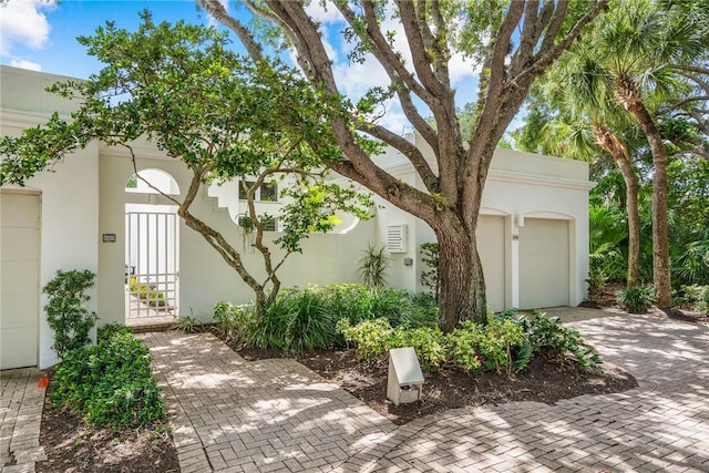 8409 Red Bay Ct Unit 8409, Vero Beach, FL 32963 - view of home's exterior featuring a garage, driveway, and stucco siding