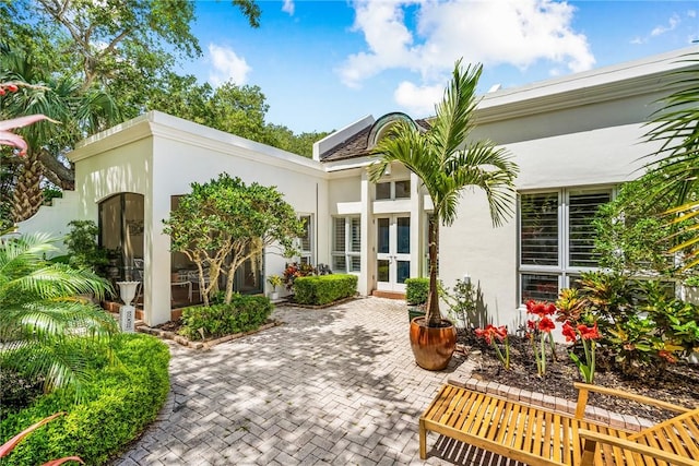 8409 Red Bay Ct Unit 8409, Vero Beach, FL 32963 - rear view of house with french doors and stucco siding