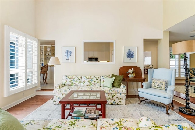 8409 Red Bay Ct Unit 8409, Vero Beach, FL 32963 - living room with a high ceiling, wood finished floors, and baseboards