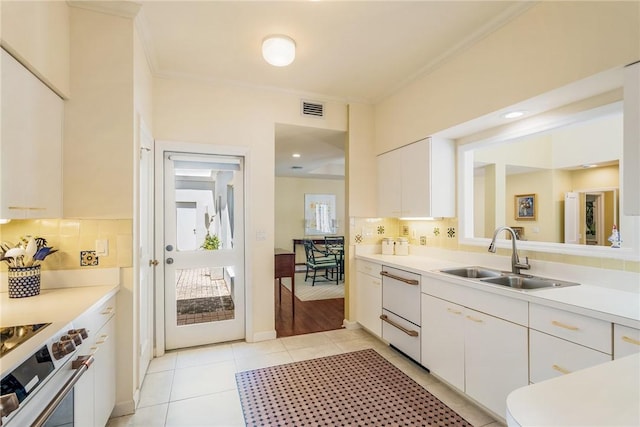 8409 Red Bay Ct Unit 8409, Vero Beach, FL 32963 - kitchen with visible vents, light countertops, a sink, and stainless steel range with electric cooktop