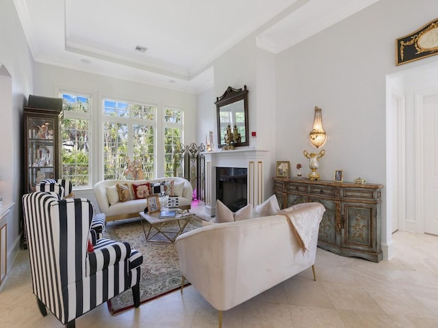 7 Beachside Dr, Vero Beach, FL 32963 - living room featuring crown molding, light tile patterned flooring, visible vents, a tray ceiling, and a high end fireplace