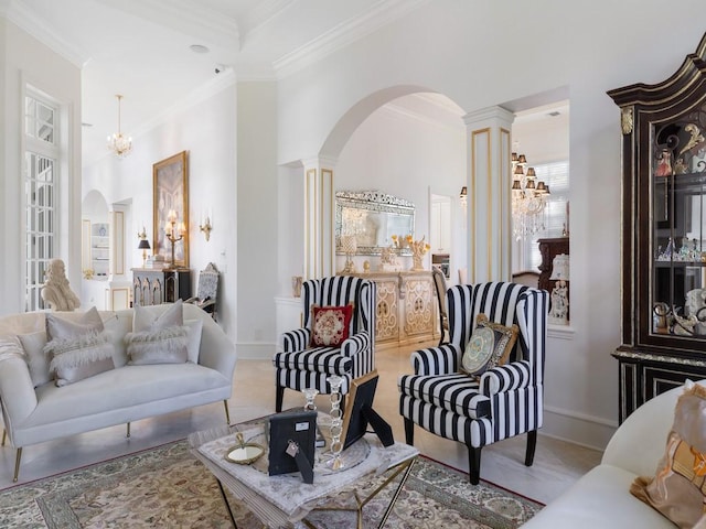 7 Beachside Dr, Vero Beach, FL 32963 - living room with decorative columns, arched walkways, ornamental molding, a chandelier, and baseboards