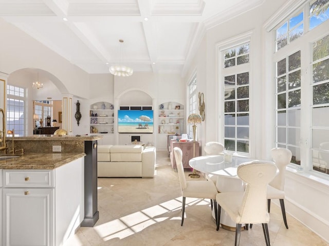 7 Beachside Dr, Vero Beach, FL 32963 - sunroom featuring a chandelier, arched walkways, plenty of natural light, and coffered ceiling