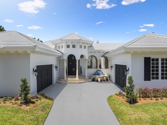 7 Beachside Dr, Vero Beach, FL 32963 - view of front of home featuring concrete driveway, a tile roof, and a garage