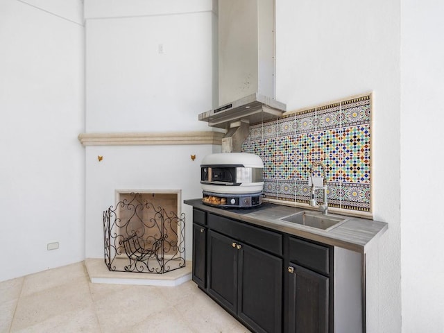 7 Beachside Dr, Vero Beach, FL 32963 - kitchen featuring wall chimney exhaust hood, a sink, dark countertops, dark cabinets, and light tile patterned floors