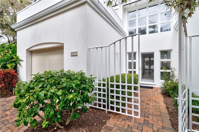 entrance to property featuring stucco siding