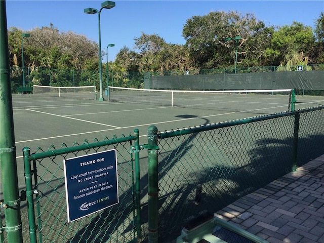 view of tennis court with fence