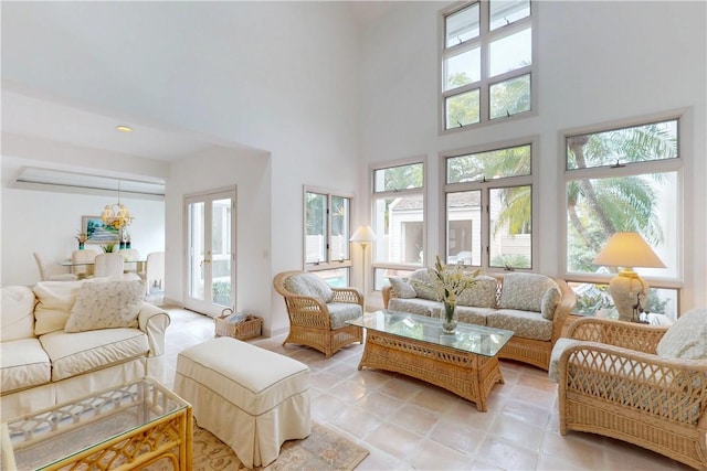 living room featuring french doors and a towering ceiling