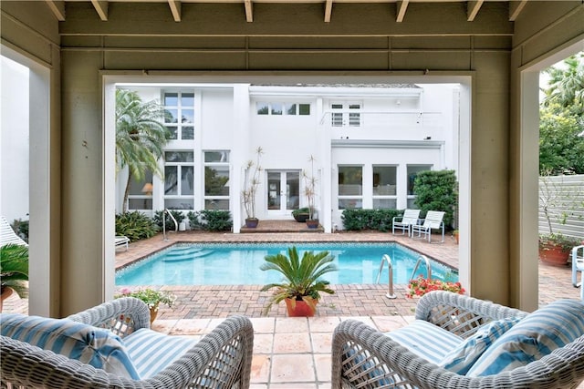 pool with french doors and a patio area