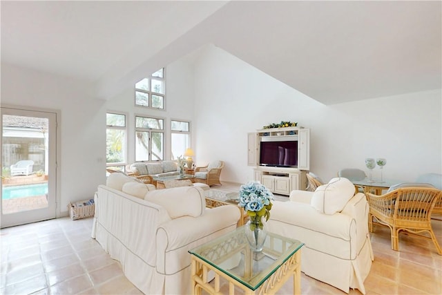 living area with high vaulted ceiling