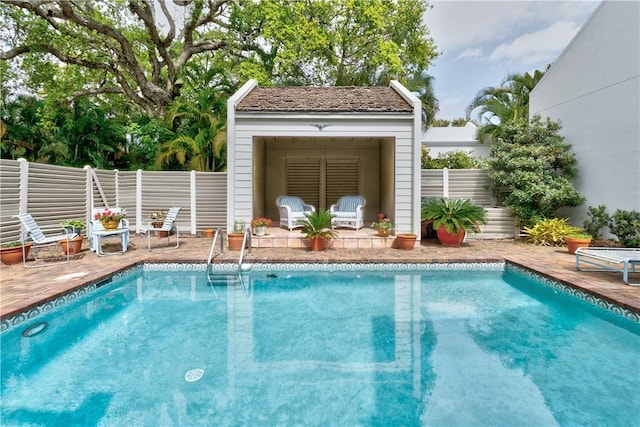 view of pool featuring a patio area, fence, and a fenced in pool