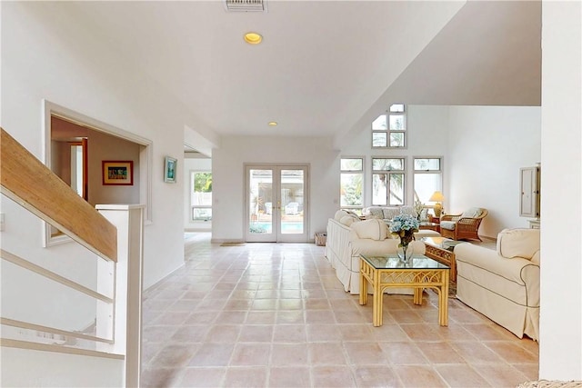 living room with light tile patterned floors, recessed lighting, and french doors