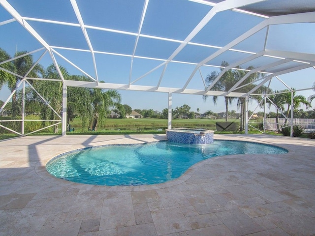 view of pool with glass enclosure, a patio, and an in ground hot tub