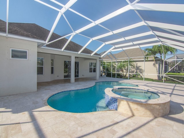 view of pool with a lanai, an in ground hot tub, and a patio area