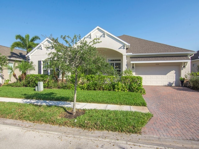 view of front of home featuring a garage and a front yard