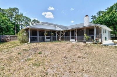 back of house featuring a sunroom